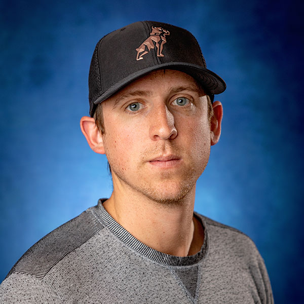 Andre Joyce, Project Manager at ECI Contracting, wearing a black cap and gray shirt, with a blue background.