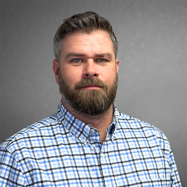 Brian Theleman, Senior Project Manager at ECI Contracting, wearing a plaid shirt against a neutral background, representing the company's leadership in underground construction solutions.