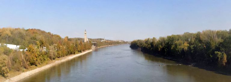 Buckeye Creek landscape featuring a wide river bordered by trees and a distant tower, illustrating the natural setting for ECI Contracting's infrastructure projects.